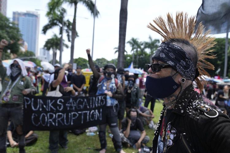 Philippine police arrested dozens after a violent clash near presidential palace, in photos