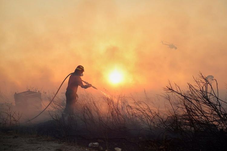 Photos of a wildfire near Athens as homes burn