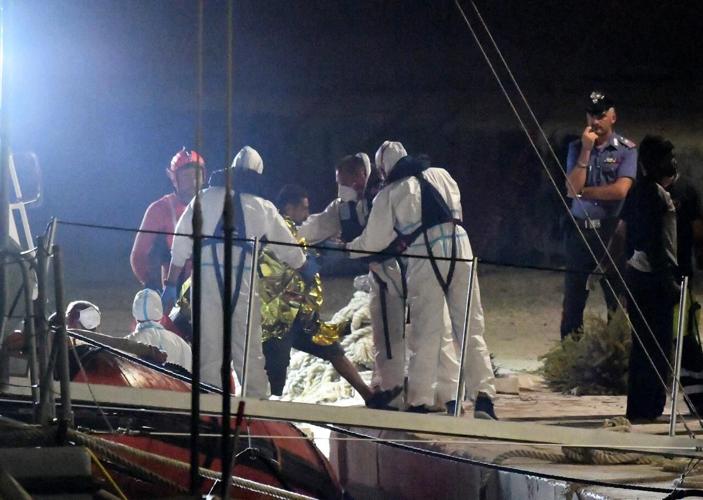 Migrants exit rescue ship in Italy after 19-day standoff