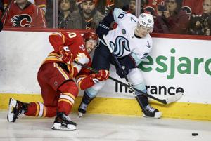 Surging Kraken score four times in third period to burn Flames 5-1