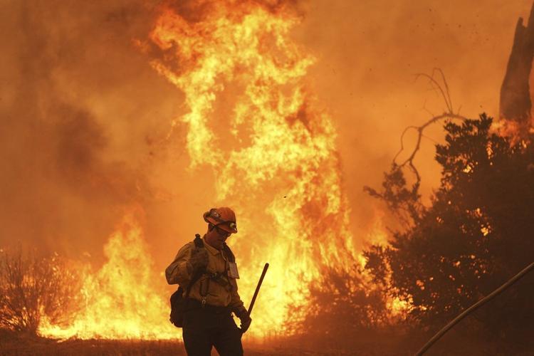 Firefighters make progress against blaze that forced thousands to flee ...