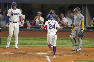 Michael Helman hits 2-run HR, make catch to prevent 2-run HR, as Rangers beat Brewers 5-4