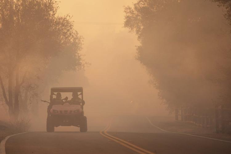 Firefighters make progress against blaze that forced thousands to flee ...