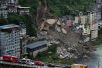 Rescuers race to find survivors in the rain after a landslide in China kills at least 8