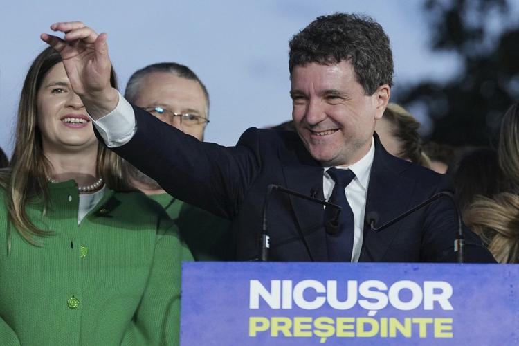 AP PHOTOS: Pro-EU centrist wins Romania’s tense presidential race over hard-right nationalist