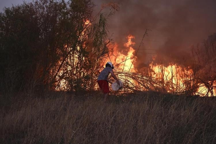 Crews battle scattered fires in Athens suburbs, helped by calmer winds