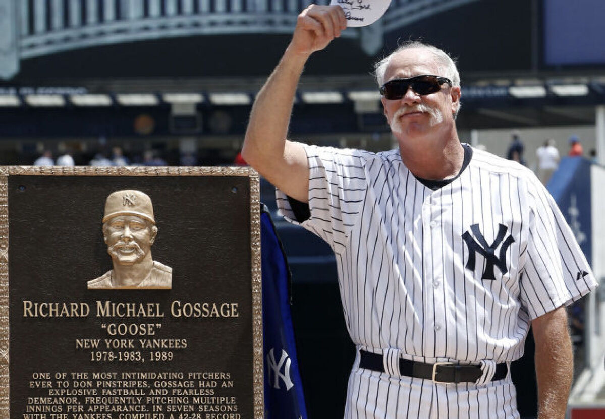 Retired New York Yankee pitcher Goose Gossage waves while standing with his  monument that will be placed in Monument Park at the 68th Annual  Old-Timers' Day before the New York Yankees play