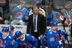 Avalanche coach Jared Bednar returns to the bench after taking a puck to the face last weekend