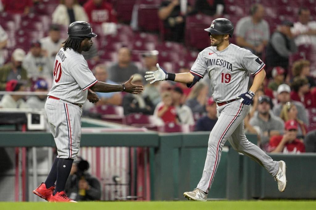Phillips gets first major league win and Benson has 3 RBIs to lead Reds  over Twins 7-3