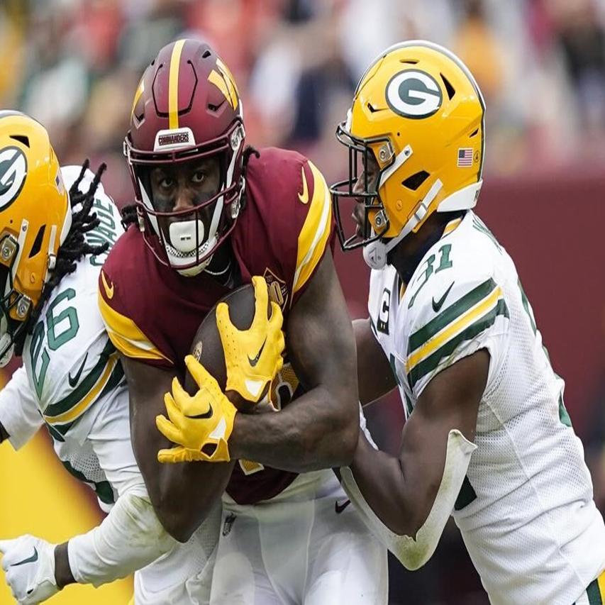 Washington Commanders quarterback Taylor Heinicke (4) throws under pressure  from Green Bay Packers linebacker Rashan Gary (52) during the first half of  an NFL football game Sunday, Oct. 23, 2022, in Landover