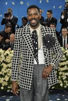 The Latest: The Met Gala opens as rain fails to dim the stars for fashion's biggest night