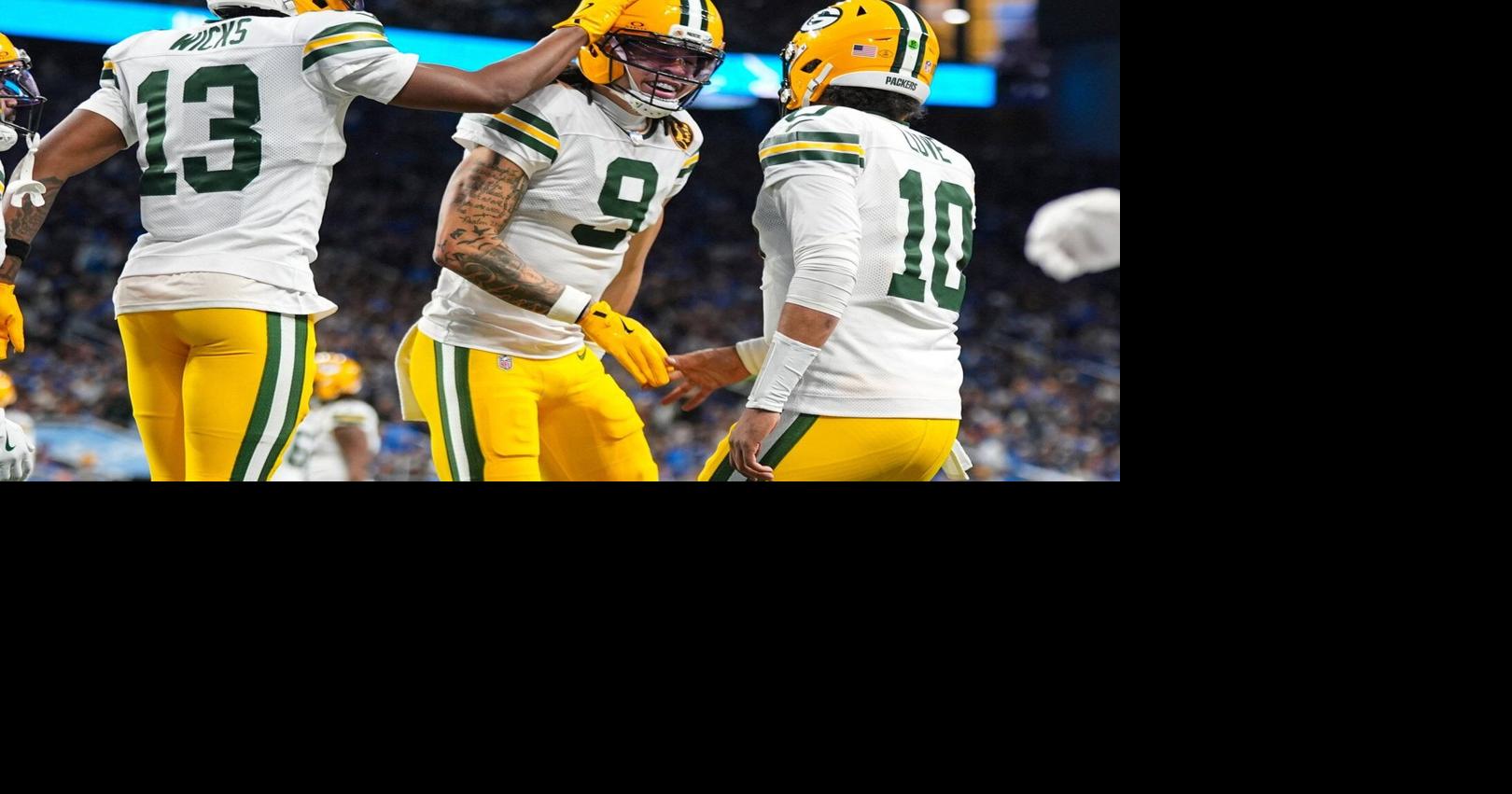 Love matches career high with four TD passes, lifting Packers to win over Lions