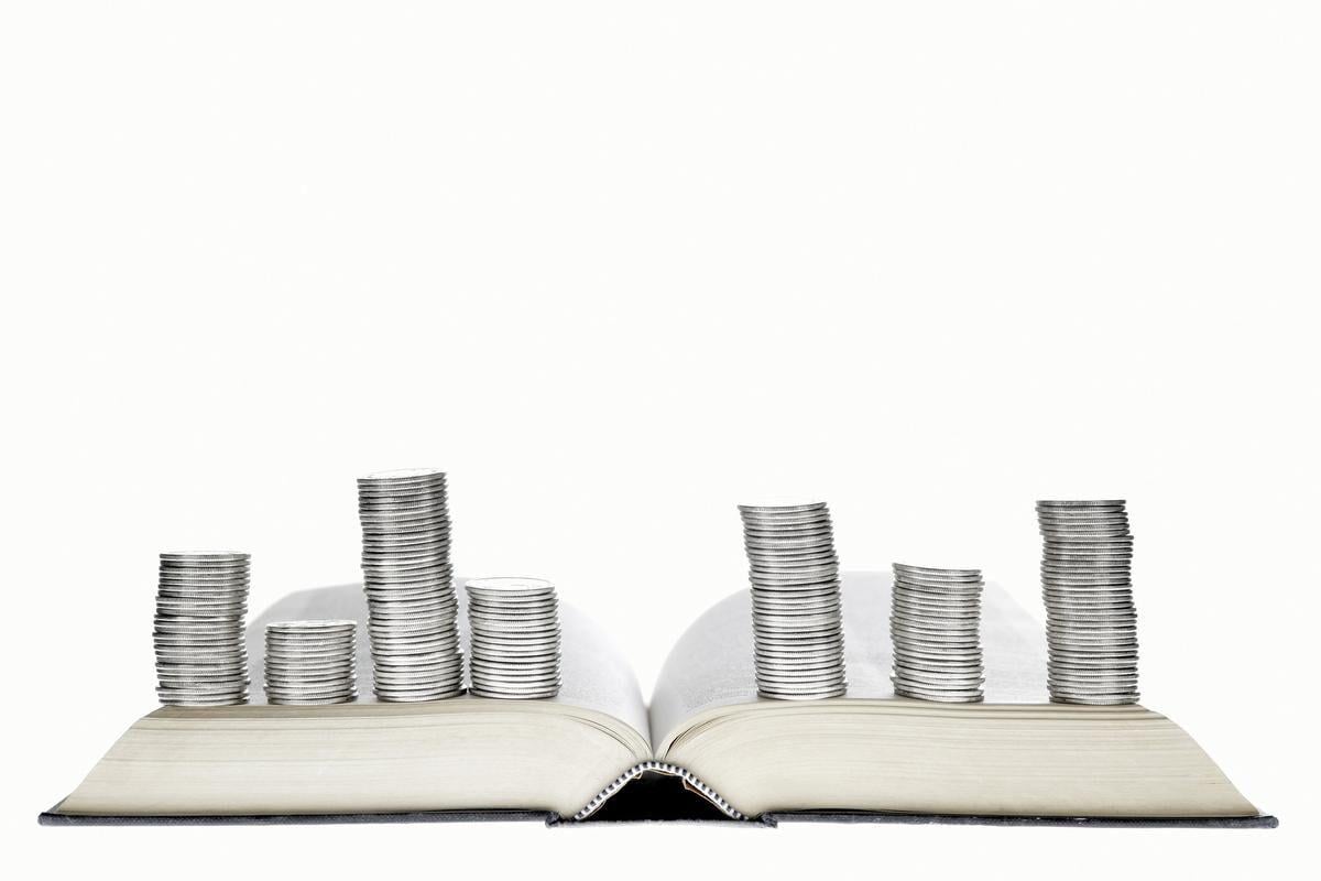 A book with a stack of coins on it.