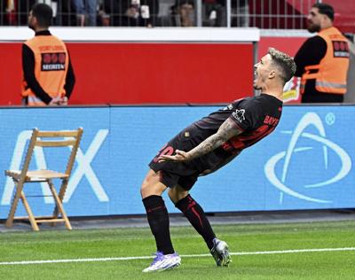 Leverkusen fights past in-form Frankfurt to earn first Bundesliga win