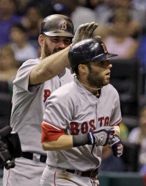 Boston Red Sox centerfielder Coco Crisp, left, is congratulated by