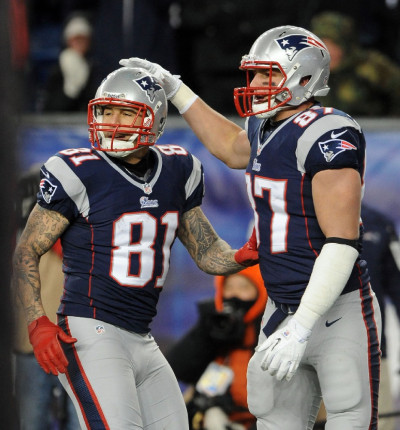 New England Patriots tight end Aaron Hernandez (81) dives into the turf  after being tripped up on a ten yard reception in the third quarter against  the Miami Dolphins at Gillette Stadium