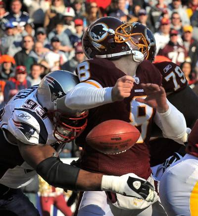 New England Patriots quarterback Tom Brady (12) leaves the field following  his team's 34 - 27 victory over the Washington Redskins at FedEx Field in  Landover, Maryland on Sunday December 11, 2011.