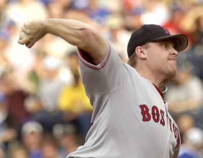 Boston Red Sox pitcher Curt Schilling takes off his jersey after