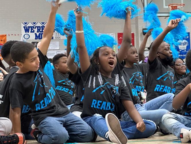 Students cheer reading at Carolina Panthers rally