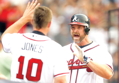 Atlanta Braves' Chipper Jones, right, celebrates with teammate