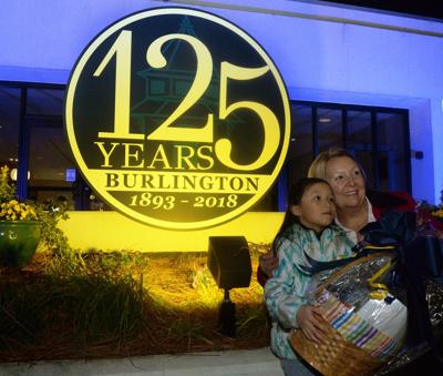 Chloe Chen, 8, a second-grade student at Smith Elementary School, won the Burlington 125th Birthday Card Contest and is with her teacher, Lori Waller, in front of the new sign at the city Municipal Building on Lexington Street to kick-off the 125th Anni...