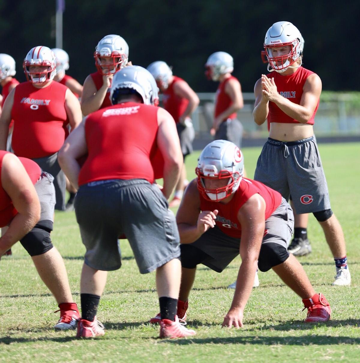 FOOTBALL IS IN THE AIR The Corbin Redhounds held their first practice in helmets today at the