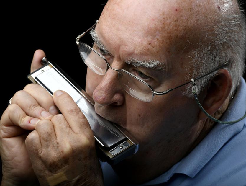 Resident shares happiness with harmonica groups