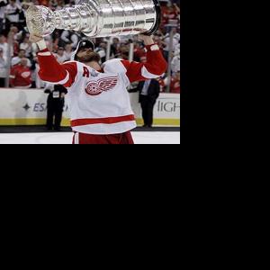 Darren McCarty and his son hoist the cup