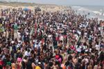 A crowd of partiers gather on the beach for Orange Crush in Tybee Island on Saturday, April 20, 2024.