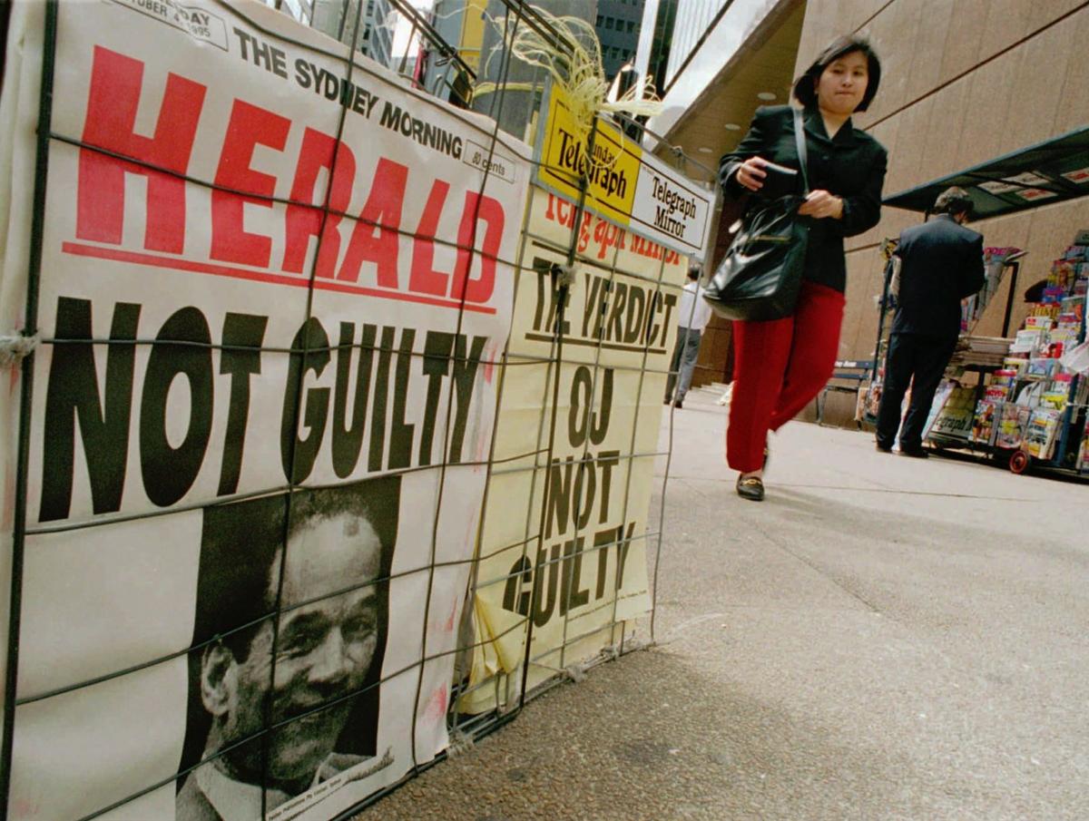 Newspaper advertising posters display the outcome of the O.J. Simpson murder trial