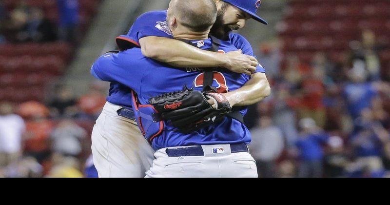 Chicago Cubs pitcher Jake Arrieta, left, receives a Championship