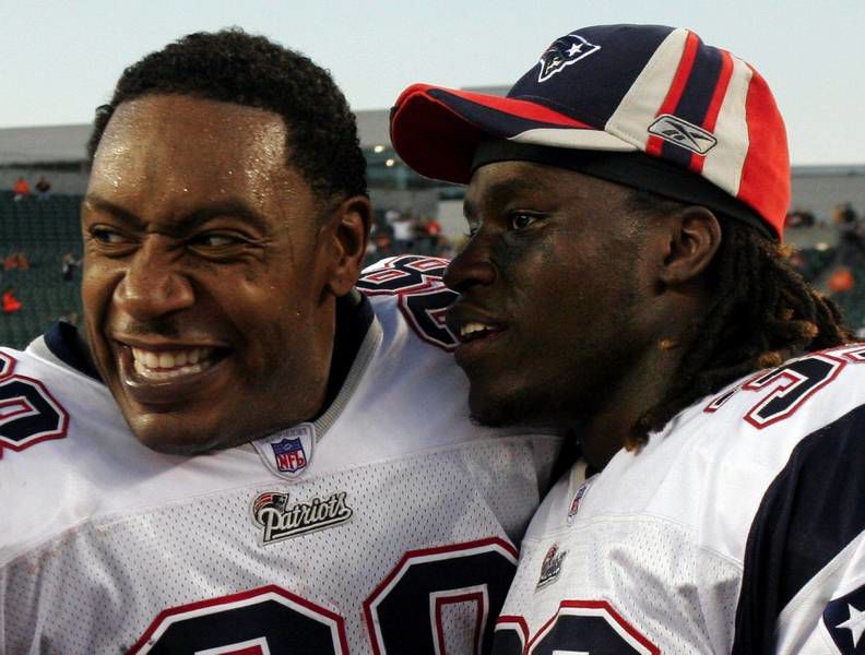 Corey Dillon of the New England Patriots shows the football after