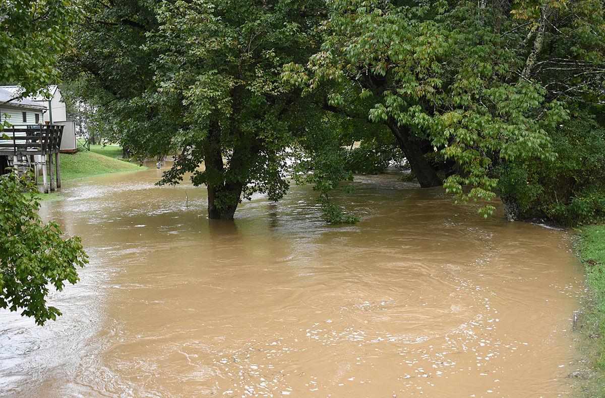 Flooding in Fairview Creeks overflow, pooling in yards, blocking roads