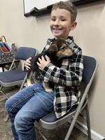 Puppies and Ozzy the Reading Dog make for fun time at the Mannington Public Library