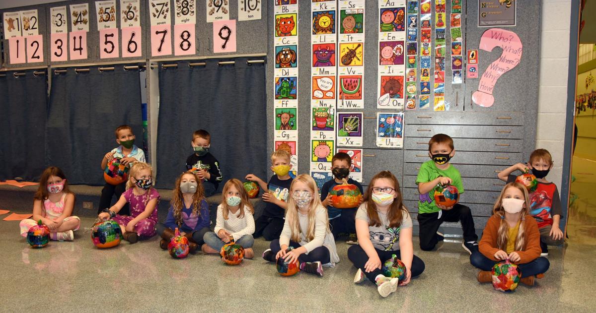 Students decorate pumpkins