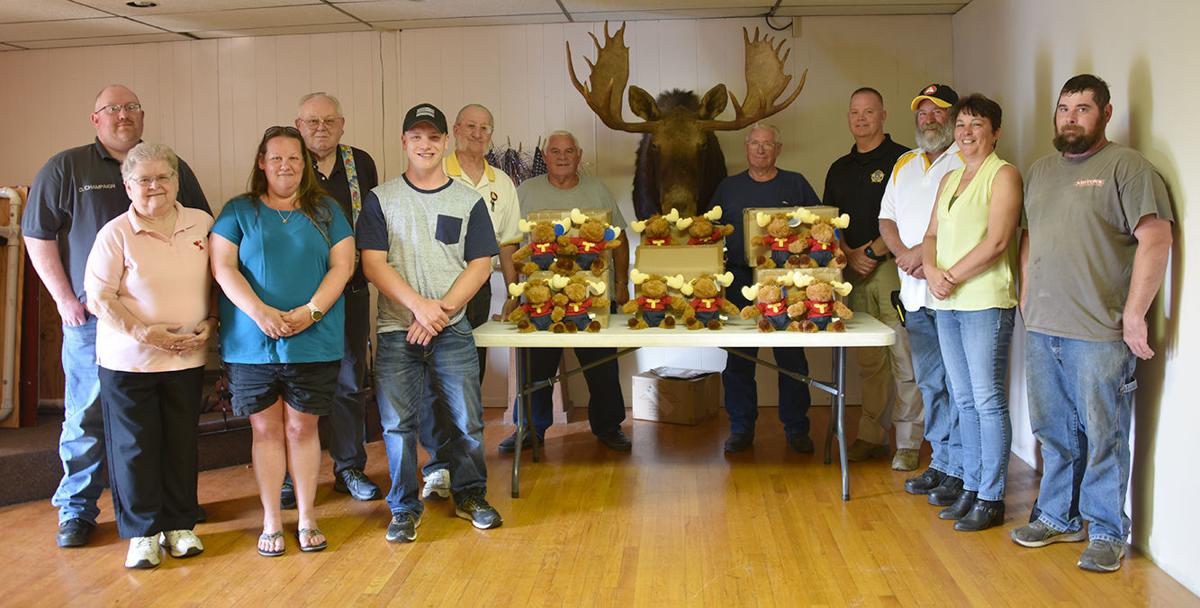 Moose presents toys to emergency responders