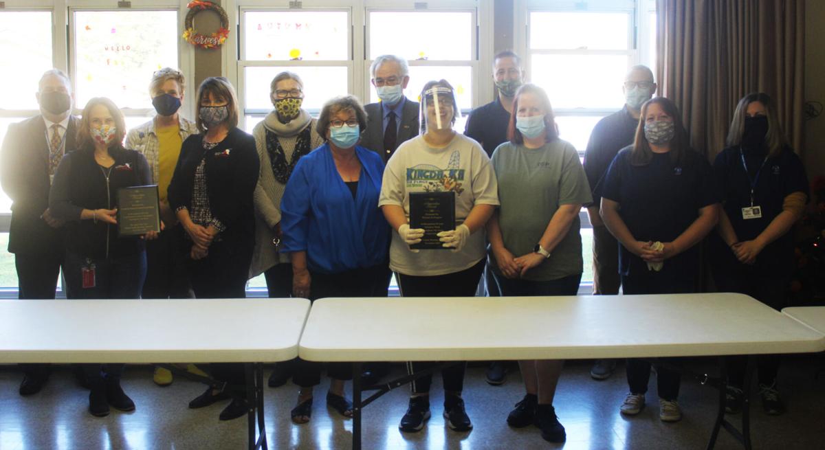 PIP, Food Bank, Housing Authority pose with plaque