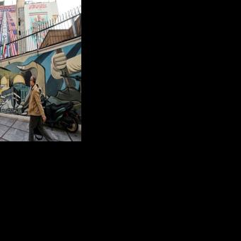 Anti-US and anti-Israel banners hang on a building in Palestine Square in Tehran