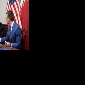 US Defense Secretary Pete Hegseth (R) and Qatari Defense Minister Sheikh Saoud bin Abdulrahman Al Thani shake hands after signing a deal to establish a Qatari Emiri Air Force training facility at the Mountain Home Air Force Base in Idaho