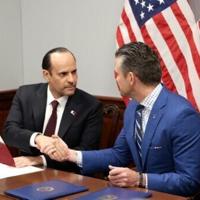 US Defense Secretary Pete Hegseth (R) and Qatari Defense Minister Sheikh Saoud bin Abdulrahman Al Thani shake hands after signing a deal to establish a Qatari Emiri Air Force training facility at the Mountain Home Air Force Base in Idaho