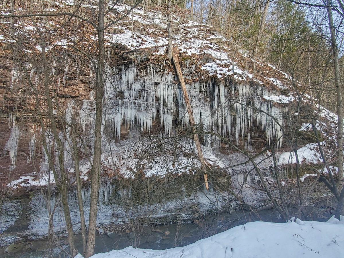 Stalactite icicles decorate cliff