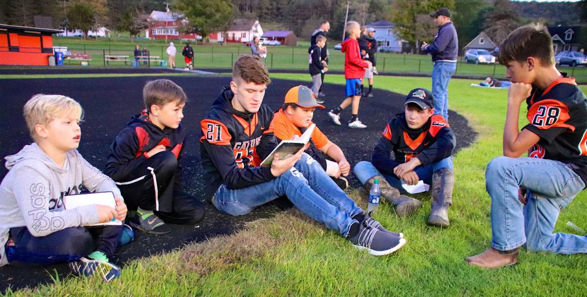 Football players read under the lights