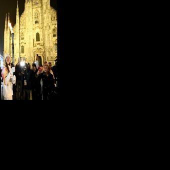 Italian ballet dancer Nicoletta Manni carries the Olympic flame in front of Milan's gothic Duomo ahead of Friday's opening ceremony