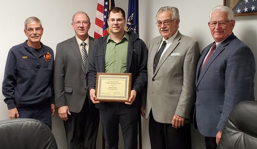 Commissioners present certification to Jones