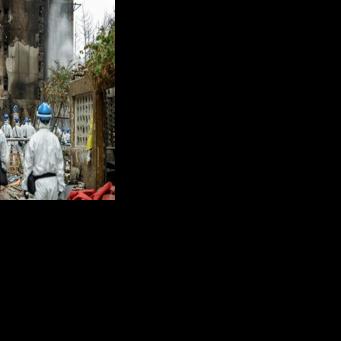 Hong Kong Police handout photo shows officers at the site of the deadly fire at Wang Fuk Court