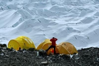In 2021 photograph, a climber looks at the Khumbu icefall from Everest base camp