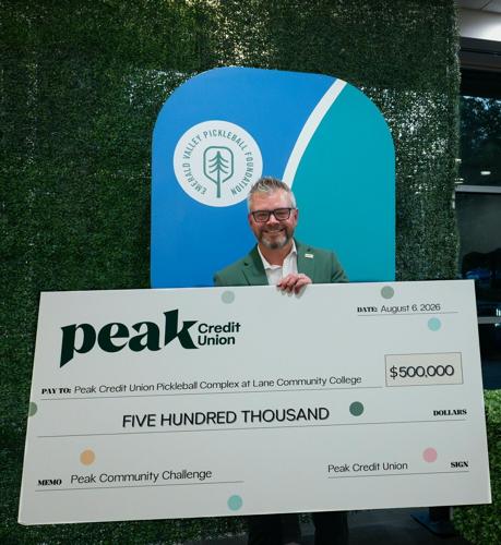 Dr. David Tuyo II, CEO of Peak Credit Union, presents a check for $500,000 to match all donations during the Peak Community Challenge in support of building a regional pickleball complex at Lane Community College