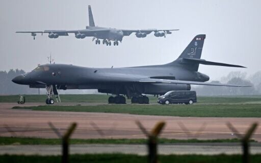 A US Air Force Boeing B-52 Stratofortress bomber jet lands on the runway, beyond a USAF Rockwell B-1 Lancer bomber jet, at RAF Fairford in south west England on March 9, 2026.