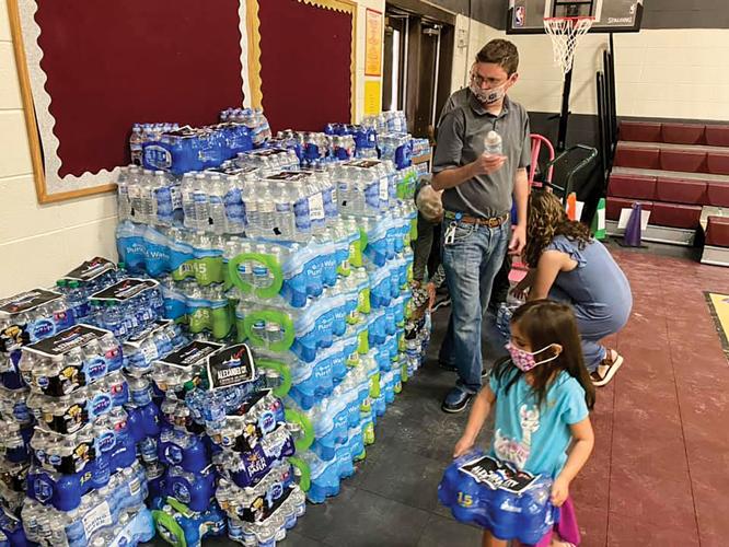 Alex City Church of Christ donates water to schools