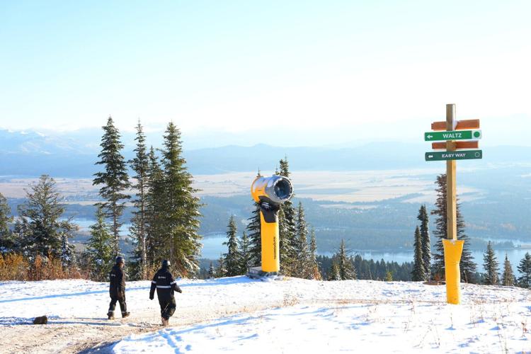 Workers check on snowguns at Tamarack Resort, with the iconic Lake Cascade in the valley below.
